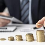 Businessman counting his profits with a calculator