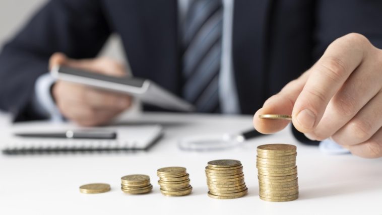 Businessman counting his profits with a calculator