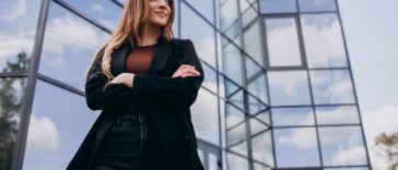 Successful entrepreneur standing by her startup's office building
