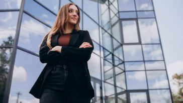 Successful entrepreneur standing by her startup's office building