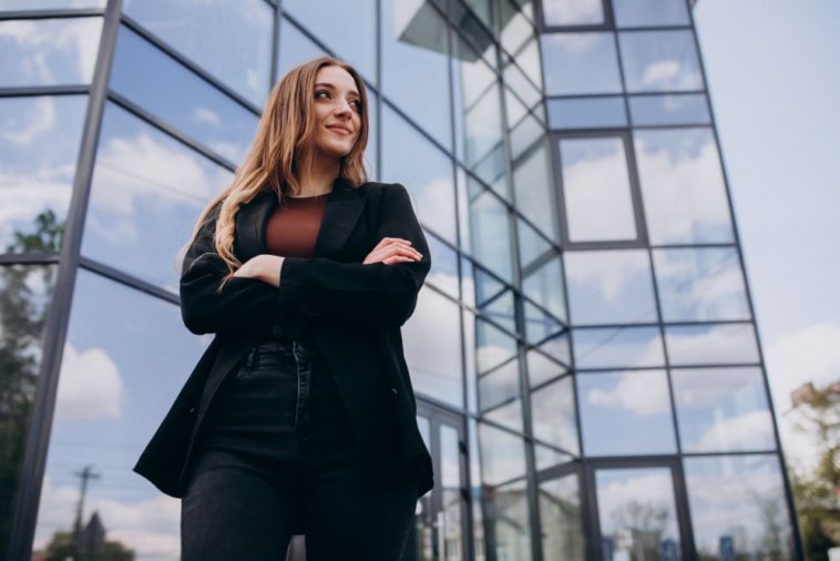 Successful entrepreneur standing by her startup's office building