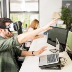 Entrepreneur using VR goggles at his tech startup
