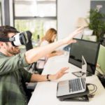 Entrepreneur using VR goggles at his tech startup