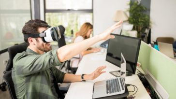 Entrepreneur using VR goggles at his tech startup