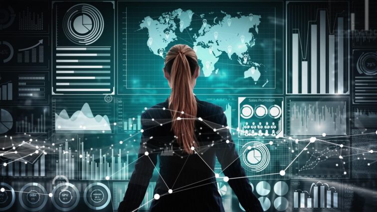 businesswoman standing in front of a holographic wall with stats and charts