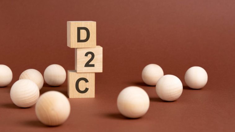 wooden cubes with d2c text on them and a brown background
