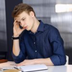 young businessman looking stressed in an office