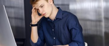 young businessman looking stressed in an office