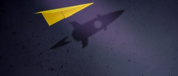 Paper plane with shadow in shape of startup rocket